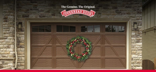 A festive brown garage door is decorated with a wreath.