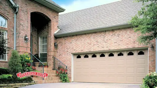 a suburban house and a tan garage door.